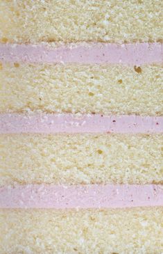 a piece of cake with pink frosting on top and three different colored strips in the middle