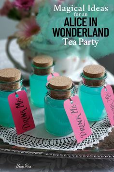 tea party favors for alice in wonderland tea party on a tray with pink and blue tags