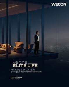 a man standing in front of a window with the words live the elite life on it