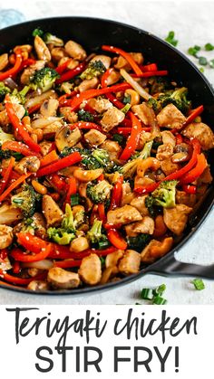 chicken stir fry with broccoli and red peppers in a skillet on a white surface