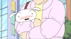 a woman holding a stuffed animal in her arms while standing next to a window sill