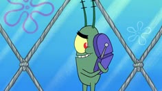 a cartoon character holding a purple object in front of a chain link fence with an octopus on it