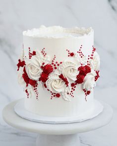 a white cake with red and white flowers on it