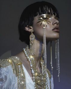 a woman with gold and silver jewelry on her face