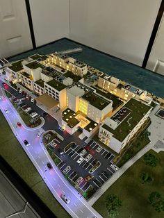 a model of a city with cars and buildings on the street at night, from above