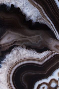 an abstract painting with black, white and brown colors on it's surface is shown