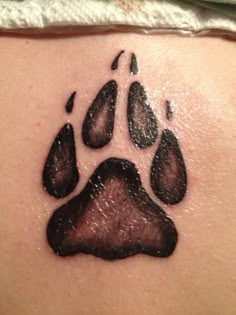 an animal paw print on the back of a woman's shoulder and chest area