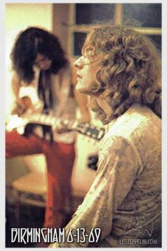two women are playing guitars in the living room