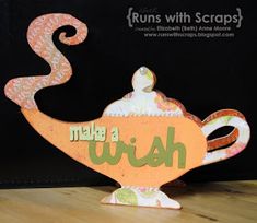 an orange teapot with the words make a wish on it sitting on top of a wooden table