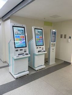 there are two electronic machines in the hallway next to each other on either side of the wall