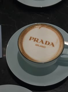 a cappuccino with the word prada written in it