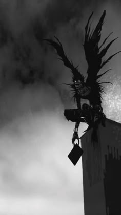 a black and white photo of a building with an evil figure on it's side