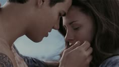 a man and woman standing next to each other with their hands on their chests