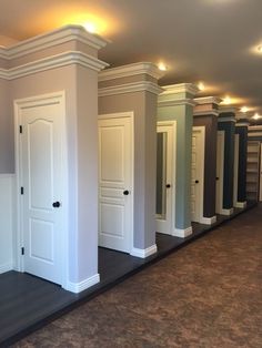 a row of closets in an empty room with lights on the ceiling and carpeted floor