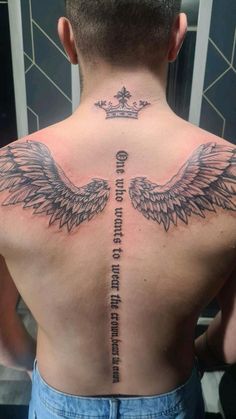 a man's back with an angel tattoo on it