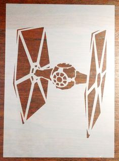 a paper cut out of a star wars tie and darth vader's fist