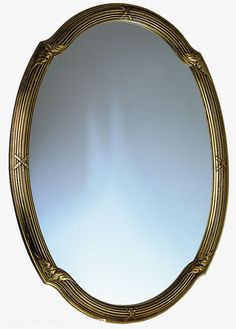 an oval mirror with gold trim on it