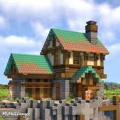 a very nice looking house made out of some sort of bricks and wood with a green roof