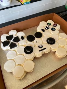 cupcakes are arranged in the shape of a video game controller on top of a cardboard box