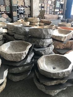several stone sinks are stacked on top of each other