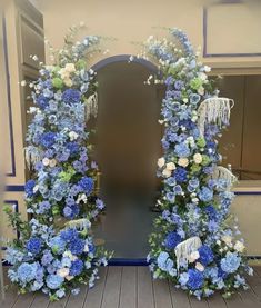 two blue and white flowers are on display in front of an open doorway with the door to another room