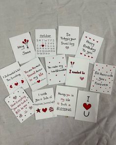 lots of handmade valentine's day cards on a bed