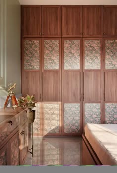 a bedroom with wooden closets and marble flooring