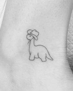 a small dinosaur tattoo on the ankle