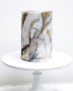 a marble cake with gold and silver decorations