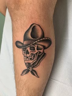 a skull wearing a cowboy hat with a bow tie on his arm, and a ribbon in the other hand