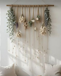 a wall hanging with flowers and greenery