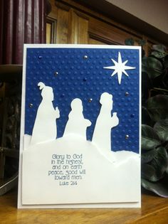 a christmas card with the silhouettes of three people and a star on top of it