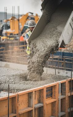 a construction worker pouring concrete into a truck