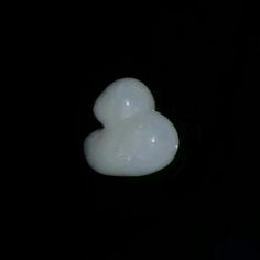 two white bubbles floating in the air on a black background, with one bubble shaped like a heart