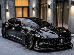 a black sports car parked in front of a building