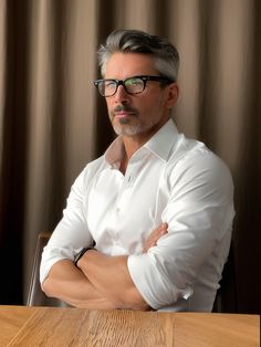 This image portrays a mature, refined style with a crisp white shirt paired with a sleek pair of glasses. The model's salt-and-pepper hair, styled neatly, adds an air of distinguished sophistication to the look. Salt And Pepper Hair Aesthetic Men, Mens 2025 Hairstyles, Silver White Hair Men, Salt And Pepper Man, Salt And Pepper Hair Mens, 2025 Mens Hairstyles, Gentleman Haircut 2025, Men Hairstyles 2025, Mens Hairstyles 2025