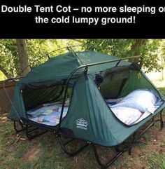 a tent is set up in the grass with its door open to allow people to sleep inside