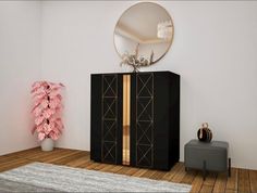 a black cabinet with gold trim in a white room next to a pink plant and round mirror