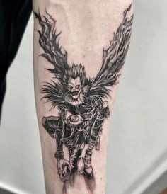 a man's leg with a tattoo on it that has an image of a demon