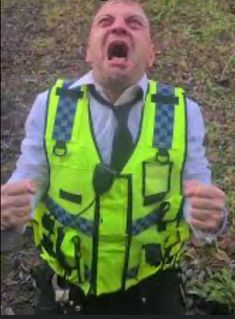 a man with his mouth open wearing a yellow vest