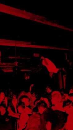 a group of people sitting in front of a red light