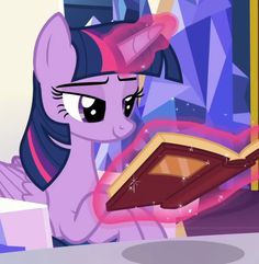a pinkie is holding a book in her hand