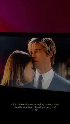 there is a man and woman kissing on the tv screen with words written below it