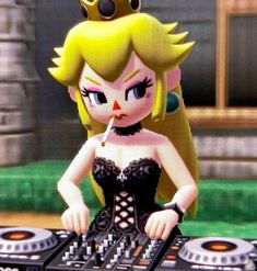 a woman in a black dress standing next to a dj mixer