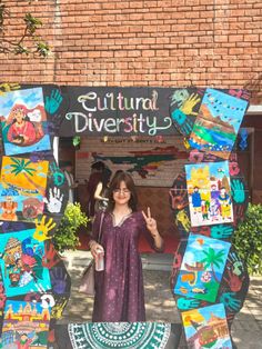 a woman is standing in front of a sign that says cultural diversity with pictures on it
