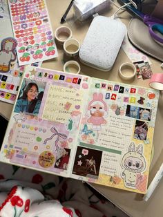 the contents of a scrapbook spread out on a table with scissors, tape and other crafting supplies