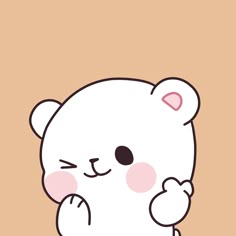 a white bear with pink cheeks sitting on top of a brown floor next to a wall