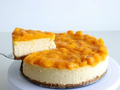 a cheesecake on a plate with a slice cut out and ready to be eaten