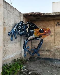 a painted frog on the side of a building