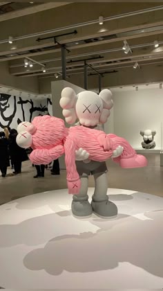 an art exhibit with sculptures and people in the background